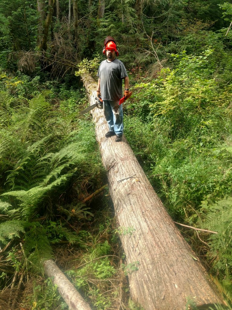 Dwayne standing on log